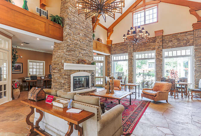 The Lodge at West Oaks lobby with stone fireplace and lounge seating