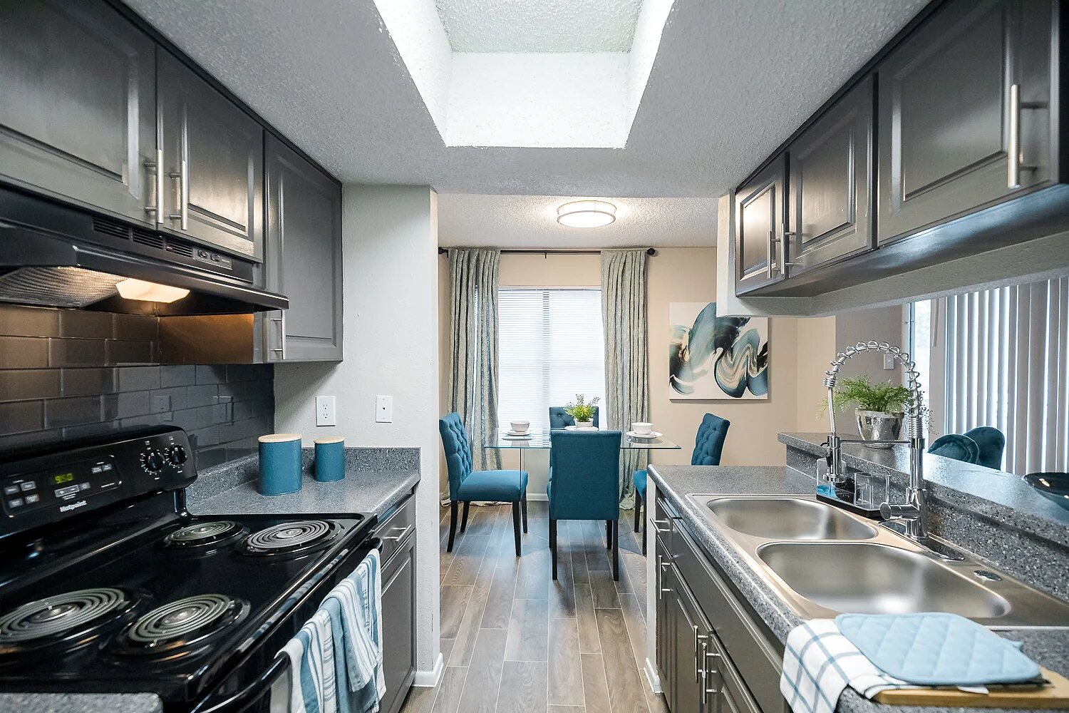 Mission at Medical apartment kitchen with dark cabinets and tile backsplash