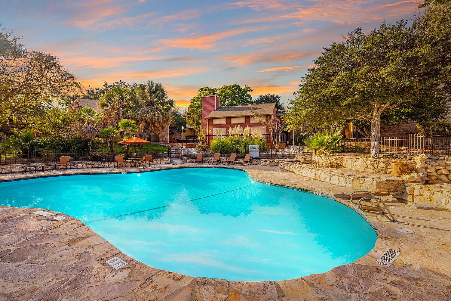 Mission at Medical swimming pool and stone patio at dusk